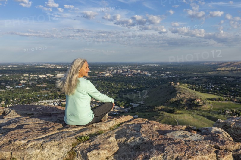Mature woman sitting on rocks in Boise