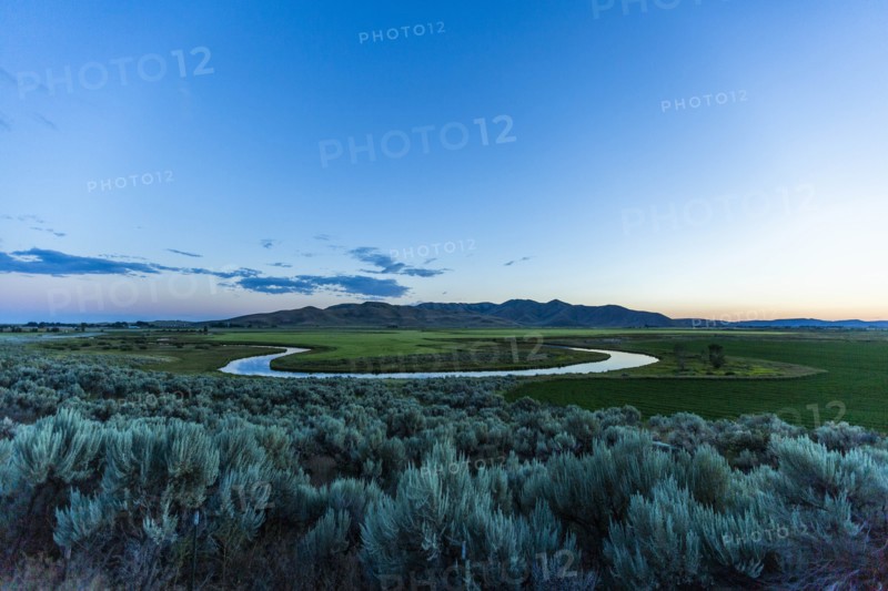 River in field at sunset in Picabo