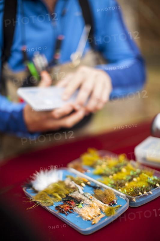 Man by box of tackle and lures