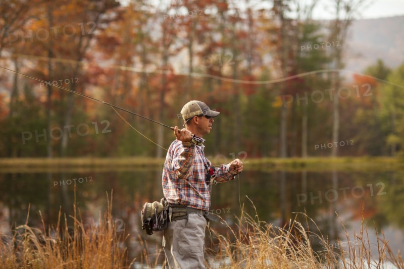Man fly-fishing in river during autumn in Giles County