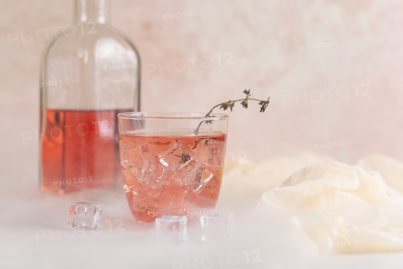 Pink cocktail with ice cubes