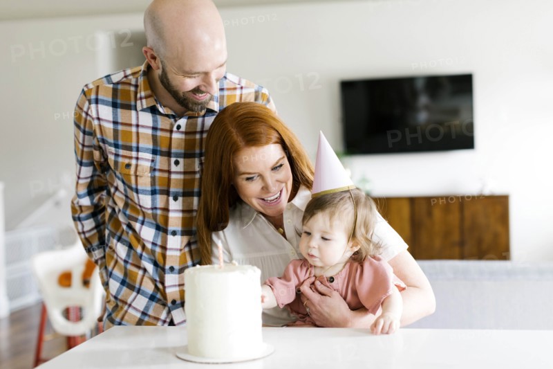 Parents and daughter with birthday cake