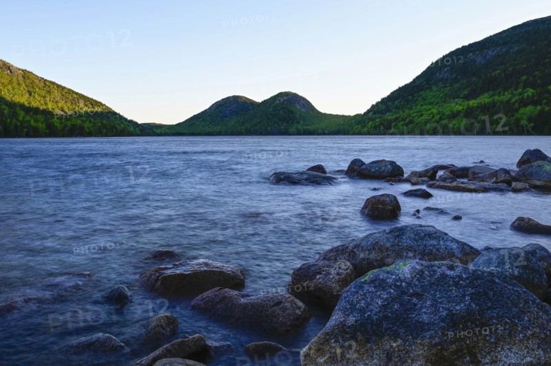 Rocks in Jordan Pond by hills in Acadia National Park, Maine, USA