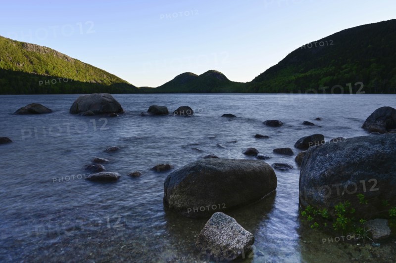Rocks in Jordan Pond by hills in Acadia National Park, Maine, USA