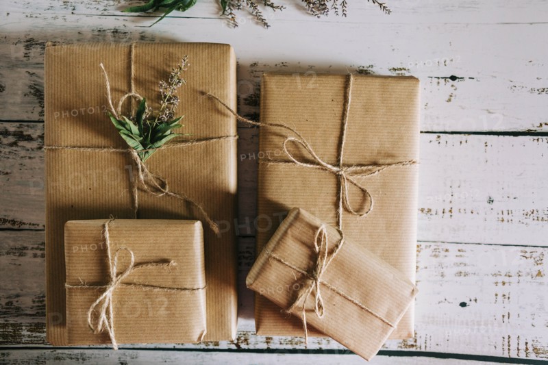 Presents wrapped in brown paper and string with flowers