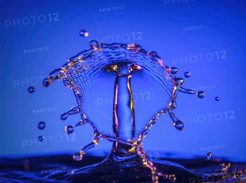 Splashing water against blue background