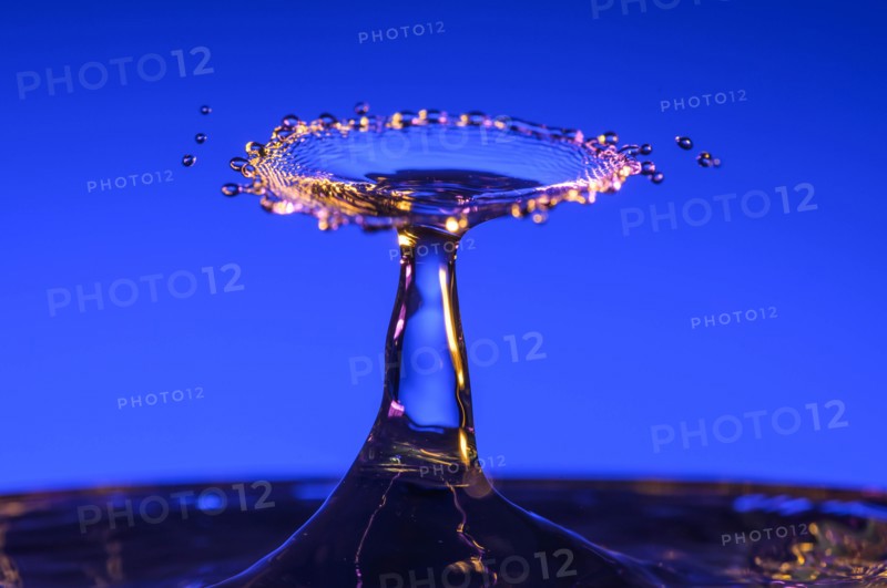 Splashing water against blue background