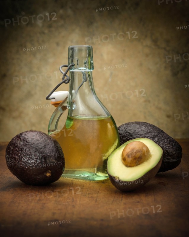 Avocados with bottle of oil