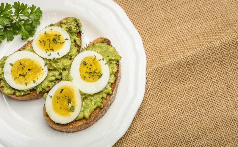 Avocado and egg on toast with parsley