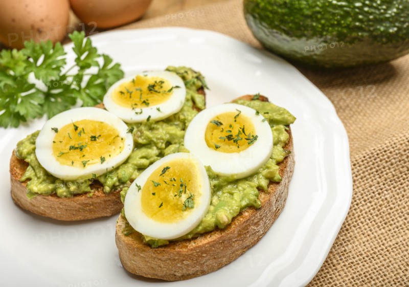 Avocado and egg on toast with parsley
