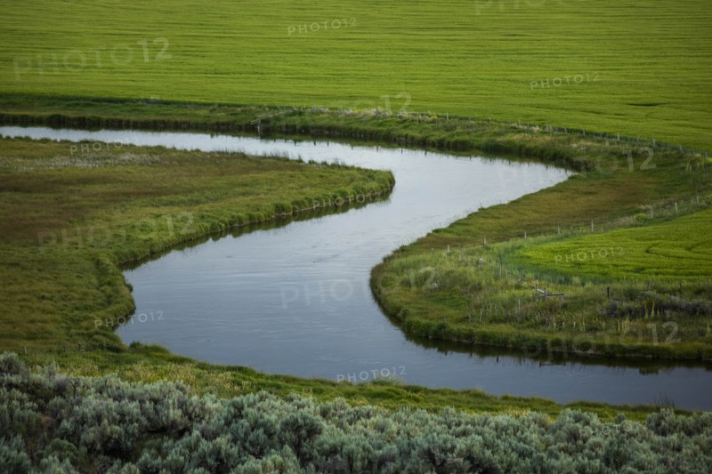 River through fields in Picabo, Idaho, USA