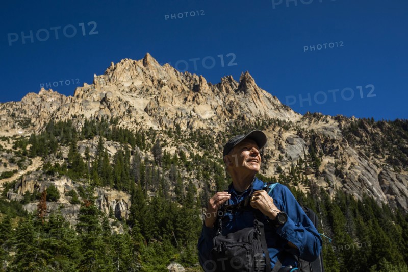 Smiling man hiking on Sawtooth Mountains in Stanley, Idaho, USA