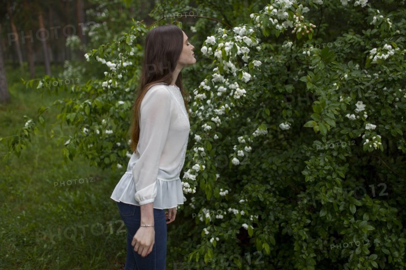 Young woman smelling flowers