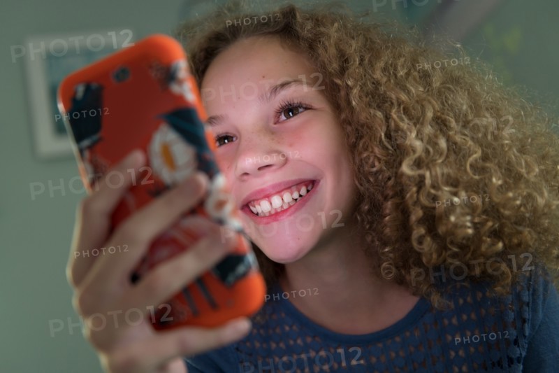 Girl smiling using smartphone