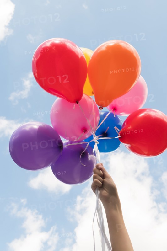 Girl's hand holding balloons