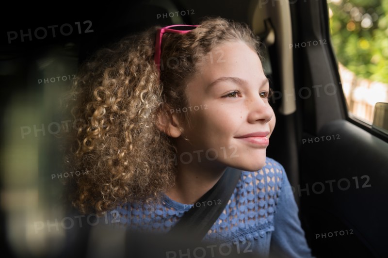 Girl wearing seatbelt in car