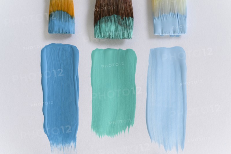 Paintbrushes and blue brushstrokes