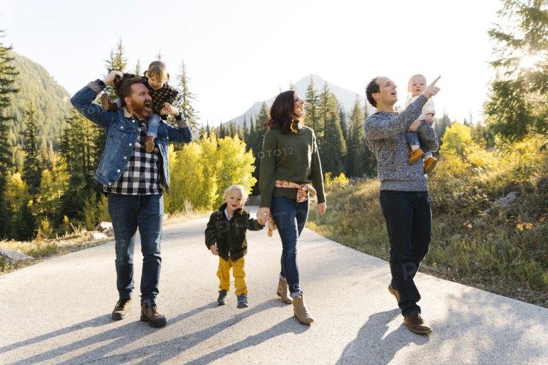 Family and friends on road through forest