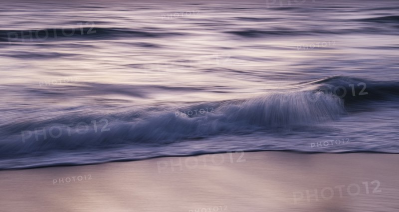 Blurred image of waves on beach