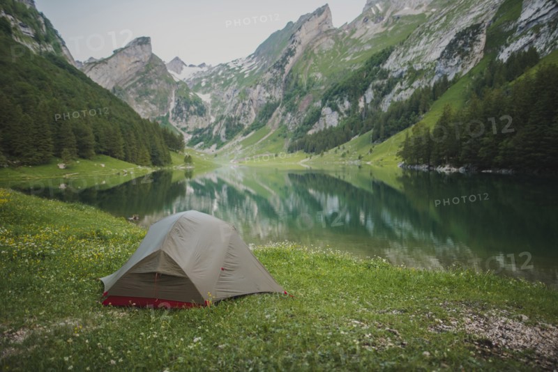 Tent by Seealpsee lake in Appenzell Alps, Switzerland