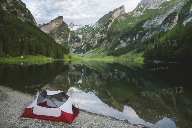 Tent by Seealpsee lake in Appenzell Alps, Switzerland