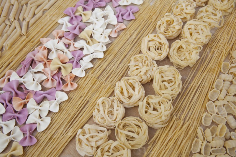 Assorted uncooked pasta in rows