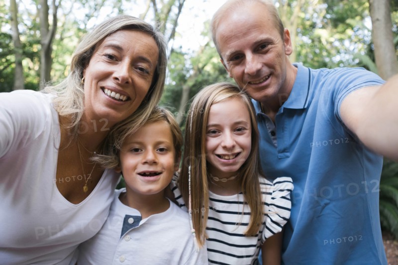 Family taking selfie by trees