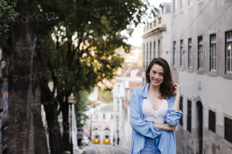Smiling woman wearing blue coat by building