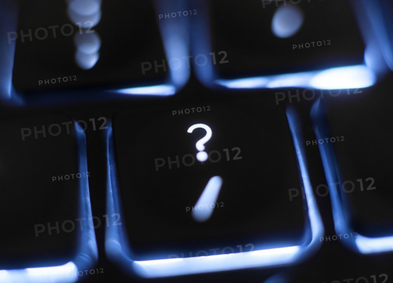 Illuminated question mark key on keyboard