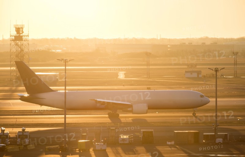 Airplane on runway at sunset