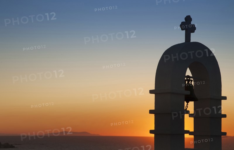 Silhouette of bell tower at sunset in Mykonos, Greece