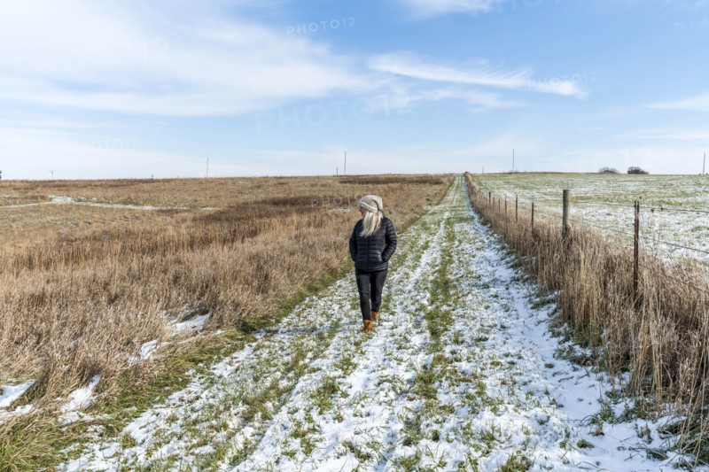 Woman walking in snowy field