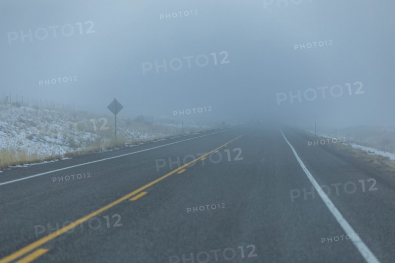 Road by snow in fog