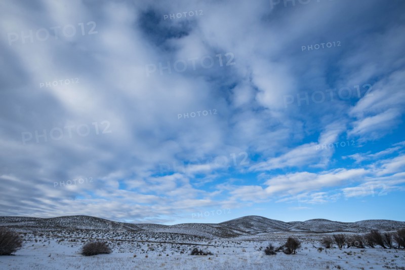 Snowy hills under cloud