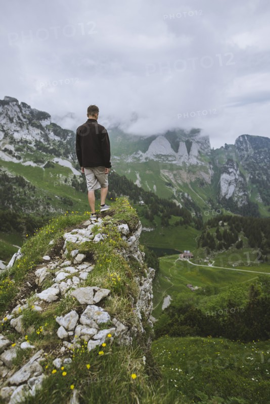 Man on rock by mountains
