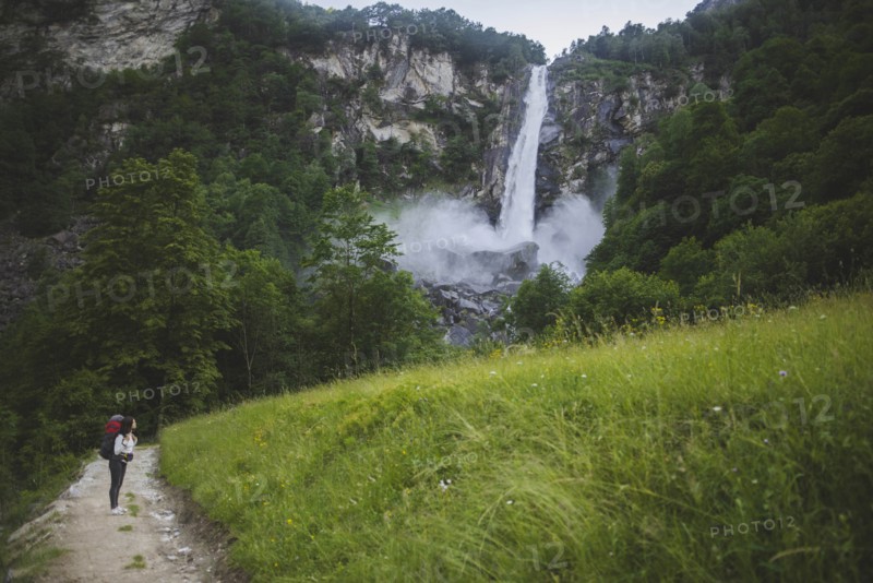 Woman on path to waterfall