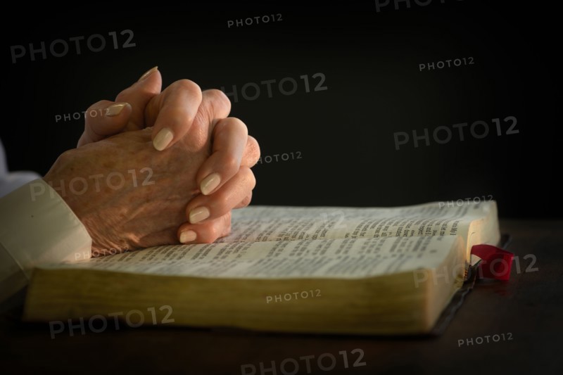 Woman's hands on open bible