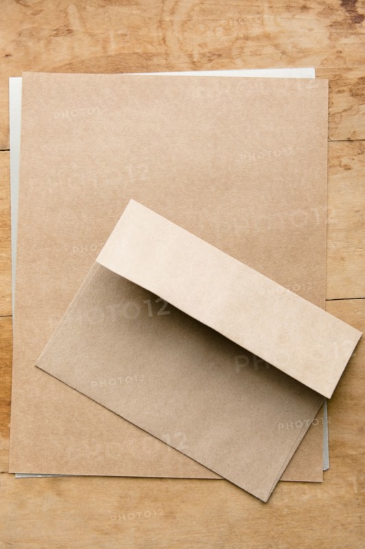 Envelope and paper on wooden table
