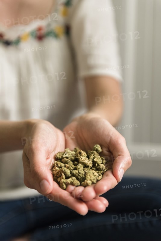 Marijuana in woman's cupped hands