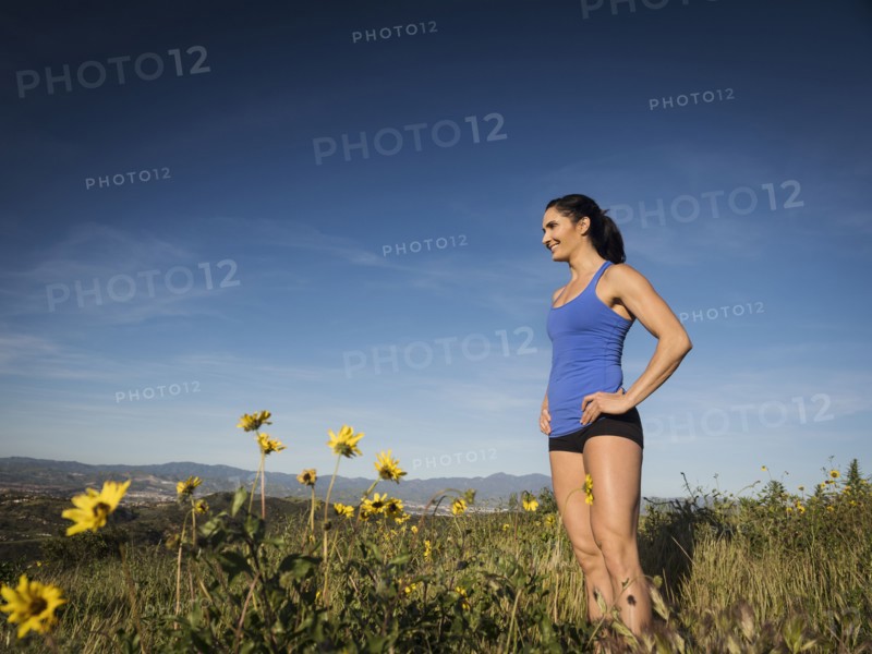 Woman in sportswear standing in meadow