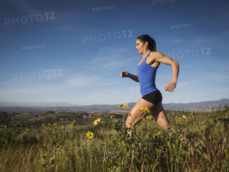 Woman jogging in meadow