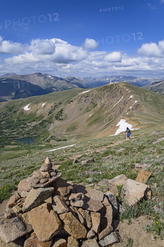 Cairn and woman hiking on Berthoud Pass Trail in Colorado