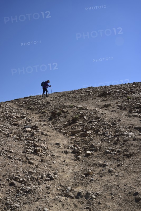 Low angle view of woman on hiking talus slope in Denver, Colorado