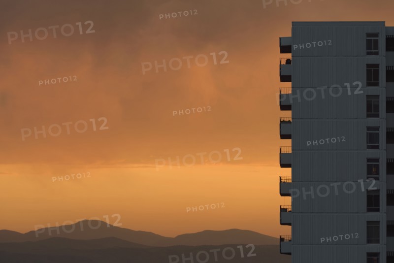 Distant wildfires and apartment building at sunset in Denver, Colorado