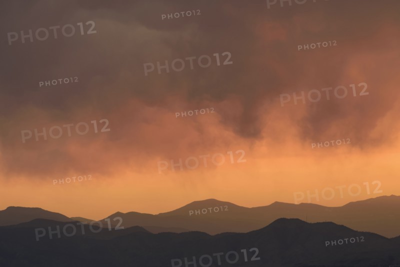 Distant wildfires and mountains at sunset in Denver, Colorado