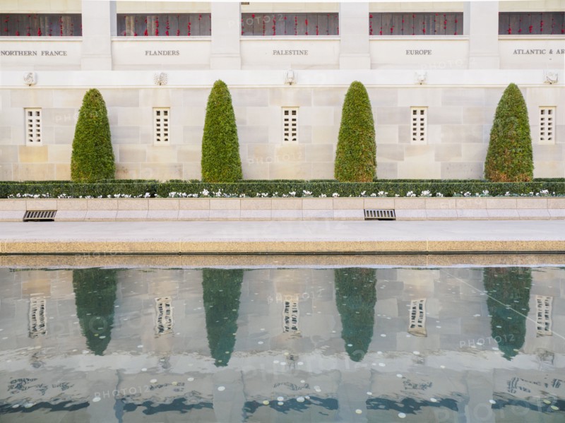 Topiary by reflecting pool at Australian War Memorial in Canberra, Australia