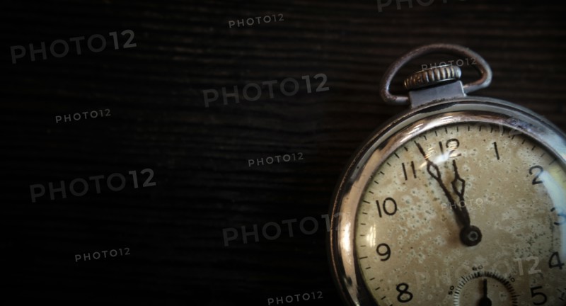 Antique pocketwatch on wooden table