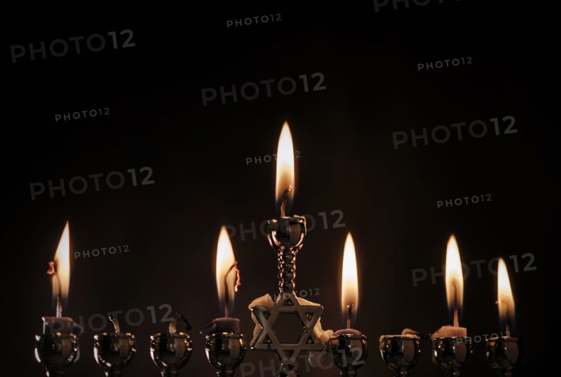Lit candles in menorah