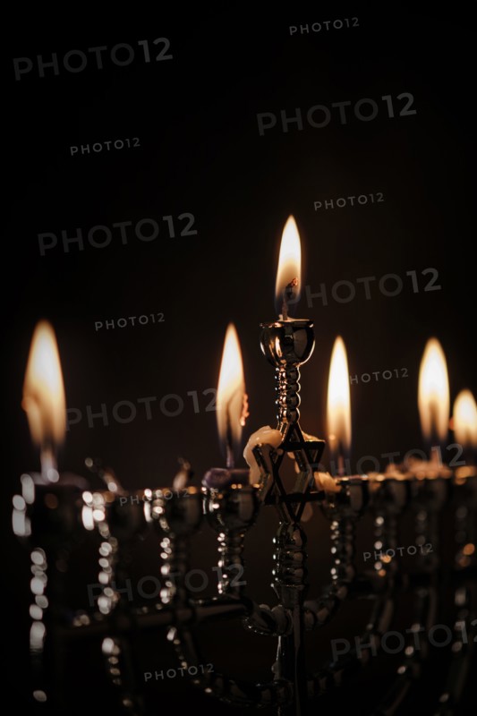 Lit candles in menorah