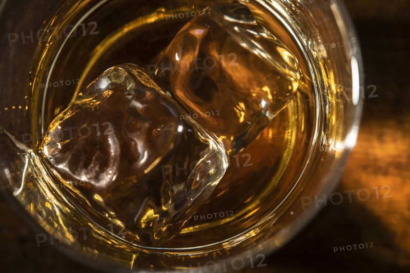 Glass of whiskey with ice cube